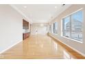 Spacious living room featuring hardwood floors, large windows and custom built-in shelving at 350 N Meridian St # 901, Indianapolis, IN 46204