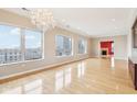 Bright living room boasts wood floors, fireplace, and cityscape views through expansive windows at 350 N Meridian St # 901, Indianapolis, IN 46204