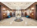 Elegant lobby features marble floors, wood paneled walls, a decorative ceiling, and crystal chandelier at 350 N Meridian St # 901, Indianapolis, IN 46204