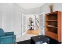 Home office with built-in shelving, and view to entryway at 11419 Romeo Pl, Fishers, IN 46040