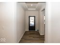 Bright entryway with dark hardwood floors and neutral walls at 18862 Shefler Blvd, Noblesville, IN 46062