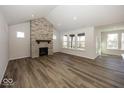 Spacious living room featuring a stone fireplace and hardwood floors at 18862 Shefler Blvd, Noblesville, IN 46062