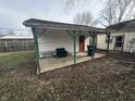 Covered patio with concrete flooring and seating area in the backyard at 728 Lonsvale Dr, Anderson, IN 46013