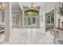 Grand foyer with tile flooring, chandelier, and views to the dining area at 9943 Irishman'S Run Ln, Zionsville, IN 46077