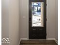 Interior view of the stylish front door with glass panel and dark hardware at 4982 Reavie Ct, Noblesville, IN 46062