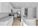 Modern, all-white kitchen with stainless steel appliances and a functional center island at 16920 Cattle Hollow Ln, Noblesville, IN 46060