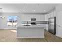 Bright, modern kitchen features a large island, stainless steel appliances, and ample counter space at 16920 Cattle Hollow Ln, Noblesville, IN 46060