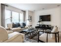 Inviting living room featuring a large window, stylish decor, and a comfortable seating arrangement at 729 Greenford N Trl, Carmel, IN 46032
