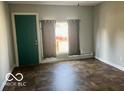 Living room with green door and tile floor at 304 Andover Rd, Anderson, IN 46013
