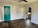 Living room with teal door and tile floor at 304 Andover Rd, Anderson, IN 46013