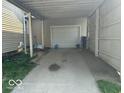 A simple one car detached garage with a white door and concrete driveway at 217 Ringwood Way, Anderson, IN 46013