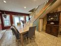 Bright dining room featuring a large table and adjacent staircase, perfect for Gathering gatherings at 7934 S 600 W, Edinburgh, IN 46124