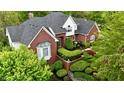Stunning aerial view of a brick home surrounded by lush landscaping and mature trees at 2838 Silverwood Ln, Greenwood, IN 46143