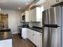 This kitchen features stainless steel appliances, white cabinets, and sleek countertops, ready for culinary adventures at 2729 Massachusetts Ave, Indianapolis, IN 46218