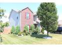 Beautifully landscaped front yard with colorful flowers and lush green lawn at 882 Brookshire Dr, Franklin, IN 46131