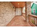 Inviting porch with brick flooring, classic railings, and ample space, perfect for relaxing and enjoying the outdoors at 1817 Bellefontaine St, Indianapolis, IN 46202