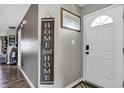 Charming foyer with decorative signage and a view into the home's interior, offering a warm welcome to visitors at 828 Ashton Park Dr, Greenwood, IN 46143