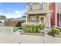 Charming two-story home with a cozy front porch and decorative landscaping at 1019 Central Ave, Indianapolis, IN 46202