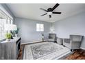 Bright living room featuring hardwood floors, grey walls, a ceiling fan, and plenty of natural light at 120 Hugo St, Indianapolis, IN 46229