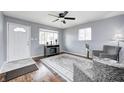 Comfortable living room featuring a ceiling fan, hardwood floors, and a view of the front yard at 120 Hugo St, Indianapolis, IN 46229