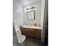 Small bathroom with wood vanity and linoleum floor at 6602 Lennington Dr, Indianapolis, IN 46226