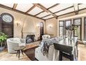 Living room with hardwood floors, fireplace, and beamed ceiling at 6996 N Washington Blvd, Indianapolis, IN 46220