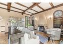 Spacious living room with hardwood floors, fireplace, and high ceilings at 6996 N Washington Blvd, Indianapolis, IN 46220