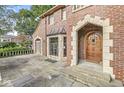 Brick home featuring a stone patio, detailed stonework, and unique architectural details at 5650 N Meridian St, Indianapolis, IN 46208