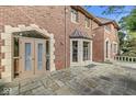 Brick home featuring a stone patio, detailed stonework, and unique architectural details at 5650 N Meridian St, Indianapolis, IN 46208