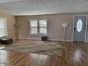 Bright living room featuring hardwood floors and a large area rug at 108 W 650 South, Pendleton, IN 46064