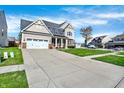 Traditional two-story home with an attached two-car garage and long driveway, perfect for guest parking at 612 Reunion Ln, Greenwood, IN 46143