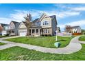 Inviting two story home featuring beautiful lawn, landscaping, and sidewalk leading to the front door at 612 Reunion Ln, Greenwood, IN 46143
