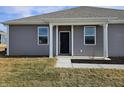 Gray townhome with a black front door and white columns at 6272 Wasco Dr, Whitestown, IN 46075