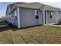 Rear view of a townhome with gray siding and white trim at 6272 Wasco Dr, Whitestown, IN 46075