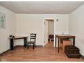 View of a living room with hard surface floors, neutral paint and multiple doorways at 850 S Holmes Ave, Indianapolis, IN 46221