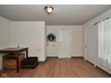 View of a living room with hard surface floors, neutral paint and multiple doorways at 850 S Holmes Ave, Indianapolis, IN 46221
