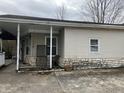 Side view of house with vinyl siding, stone foundation and porch area at 850 N Anderson St, Elwood, IN 46036
