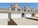 A row of townhomes with two-car garages and driveways, showcasing the community's layout at 6286 Wasco Dr, Whitestown, IN 46075