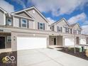 Street view of new townhomes with attached garages, attractive landscaping, and modern design elements at 6296 Wasco Dr, Whitestown, IN 46075