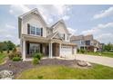 Well-manicured lawn leads up to this two-story home with brick and neutral colored siding at 1220 Greenwood Station Blvd, Greenwood, IN 46143