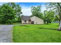 Traditional home surrounded by mature trees and lush greenery, providing a serene setting at 2747 E Midland Rd, Indianapolis, IN 46227