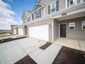 New construction townhome with a two-car garage, brick accents and neutral siding at 6314 Wasco Dr, Whitestown, IN 46075