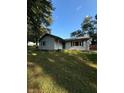 Charming single-story home with a well-maintained lawn and mature trees under a clear blue sky at 8855 N Waverly Park Rd, Martinsville, IN 46151