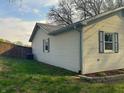 Exterior side view showing the yard and fence with white siding and blue shutters at 8855 N Waverly Park Rd, Martinsville, IN 46151