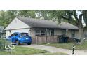 Inviting single-story home featuring a well-kept lawn, light siding, and a spacious driveway with room for multiple vehicles at 1902 Edgemont Way, Anderson, IN 46011