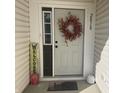Inviting front entrance adorned with a decorative wreath and seasonal decor at 2018 Abbey Ln, Columbus, IN 47201