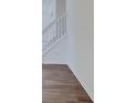 Elegant staircase with white railings and wood flooring, creating a bright and open feel at 3567 Windstar Ct, Columbus, IN 47203