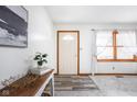 Inviting entryway featuring a charming front door, stylish console table, and ample natural light through the windows at 7655 Westerville Dr, Clayton, IN 46118
