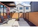 Private backyard featuring a modern fence, stone pavers, and cozy seating at 1676 Solebar Way, Westfield, IN 46074