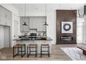 Modern kitchen with sleek black countertops, gray cabinetry, and a cozy breakfast bar at 1676 Solebar Way, Westfield, IN 46074